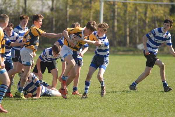 An attempted tackle between two school boys' rugby teams at the Welsh Osprey's Challenge event