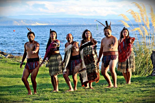 Māori cultural group performs in traditional dress at the shores of Lake Taupō